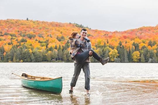 Happy couple after canoe trip at lake in Canada