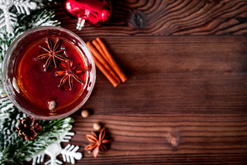 cup with christmas mulled wine on wooden background top view