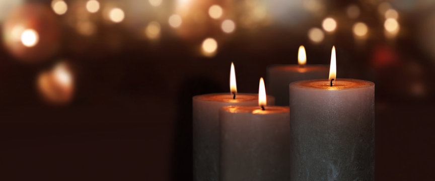 Burning candles with golden lights