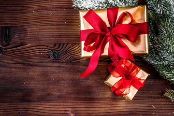 Fototapeta na wymiar gifts boxes with fir branches on wooden background top view