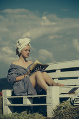 Woman reading book on bench