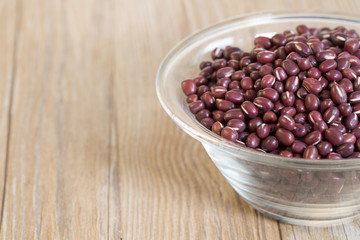 Red beans in a glass bowl on the table.