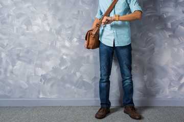 Vintage men clothings retro style with low key lighting over loft concrete wall background.