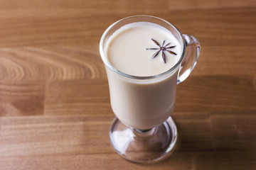 The hot alcoholic drink eggnog on wooden background