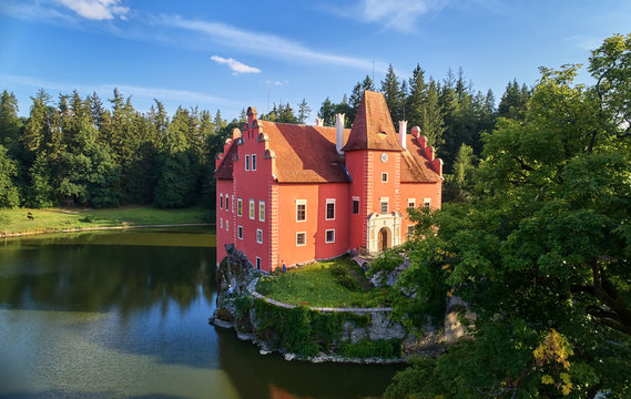 Aerial view of bizarre water castle Cervena Lhota,  picturesque renaissance-style red château standing at the middle of a lake on a rocky island in the czech landscape, south Bohemia, Czech Republic.