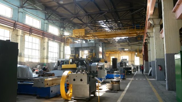 Overhead crane moves in a large factory