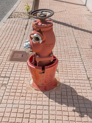 Old water post or fire hydrant in a streen in Spain