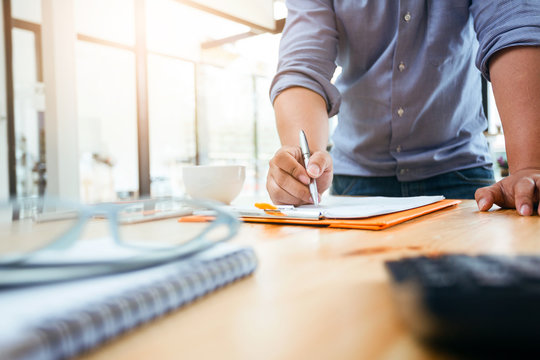 Business man using calculator to calculating.