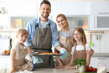 Family with pizza in kitchen. Cooking classes concept