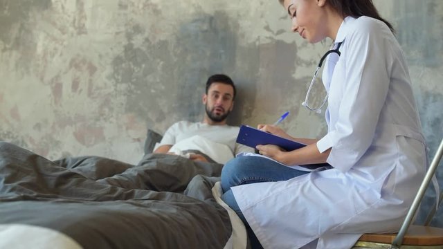 Female doctor visiting male patient at home