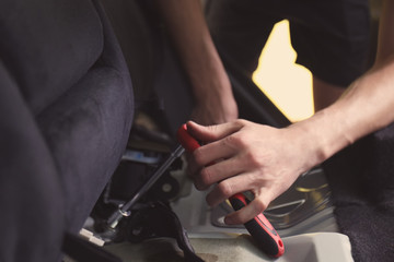 Auto mechanic fixing car in repair shop