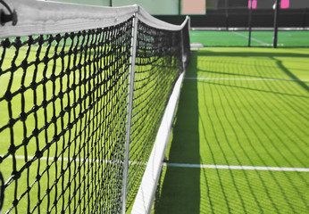 Tennis net on court in sunny day