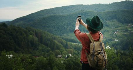 Fototapeta na wymiar tourist girl with phone and backpack