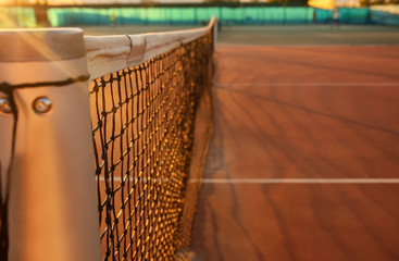 Tennis net on court at sunset