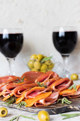 Marble ham and cheese with pumpkin seeds on a rustic board