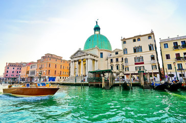 View of the Grand Canal and Venetian houses on a sunny day in Venice
