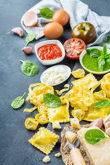 Fototapeta na wymiar Italian food and ingredients, ravioli pasta tortellini pesto tomato sauce