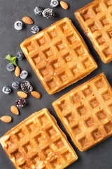 Crispy wafers with berries, vertical, top view, black background, close-up, soft focus