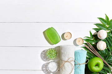 Spa products. Bath salts, soap, candles and towel. Flat lay on white wooden background, top view.