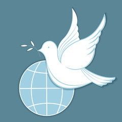 White dove with an olive branch against the background of the globe. Concept for the Day of Peace.