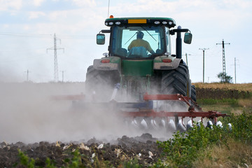 Tractor harrowing the field