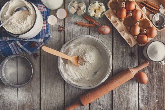 Baking ingredients on rustic wood background