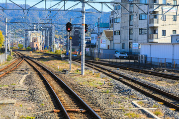 Fototapeta premium Train track at Uji Station with Mountain Backgroud.