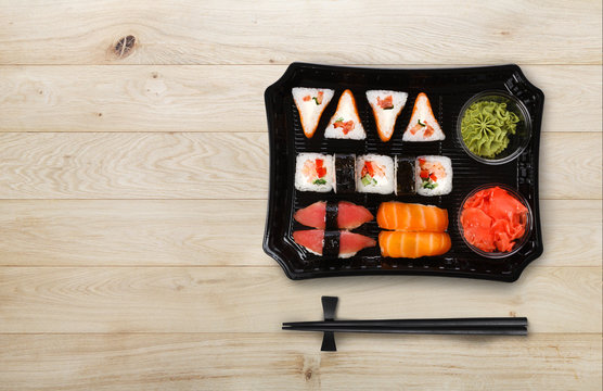 Japanese food delivery. Set of sushi and rolls top view on wood