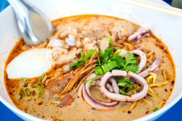 Chinese egg noodles with seafood spicy soup or called tom yum soup