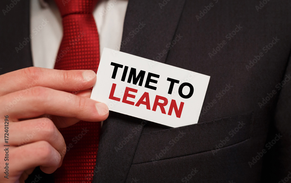 Poster businessman putting a card with text time to learn in the pocket