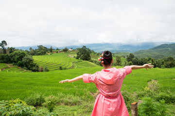 Asian woman relaxing in rice terraces fields on holiday