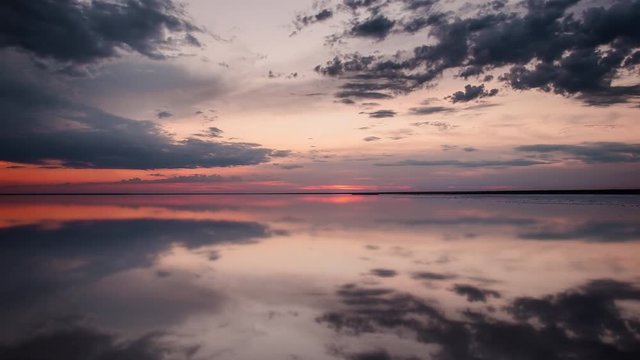 Mirror reflection on the lake. Sunset reflects in the watery surface of Lake Elton.
The large salt lake of Elton. Calm on the lake. Reflection of clouds is falling in water. TimeLapse. 