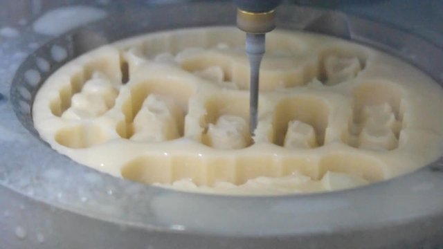 Works of the dental milling machine close-up. Processing of carving out shape of human teeth from dental milling machine. Modern medical technologies. 4.0 industrial revolution.