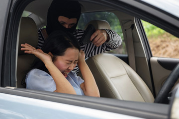 robber man point  gun at car owner