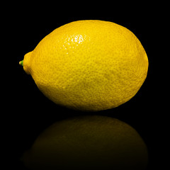 Fresh lemon isolated on the black background