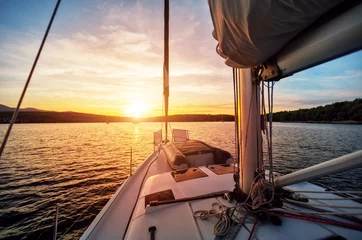 Papier Peint photo Naviguer Close-up of yacht sailing against beautiful sunset