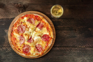 Pepperoni pizza with white wine, and place for text