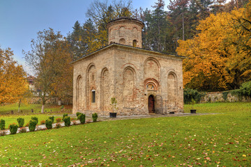 Fototapeta na wymiar Beautiful stone monastery in autumn forest