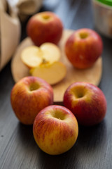 Red apples on black wooden table background.