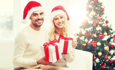 Fototapeta na wymiar happy couple at home with christmas gift boxes