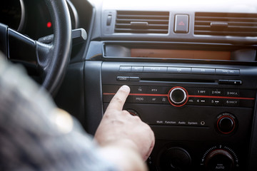 Car audio player-listening music in car.