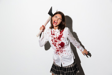 Mad woman in blood splattered shirt ready to attack © Drobot Dean