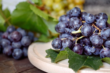 juicy black grapes on the table background.