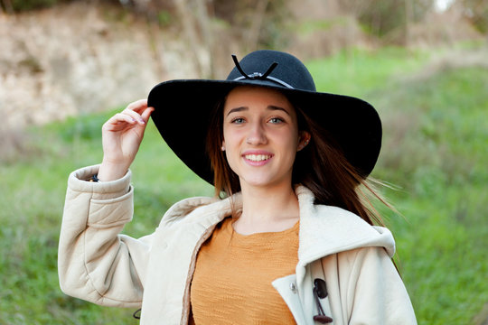 Stylish young woman with big hat