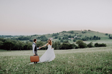 Beautiful bride and groom at sunset in green nature.