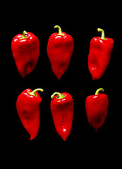 healthy red pepper isolated on black.