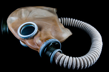 Vintage gas mask isolated on black.