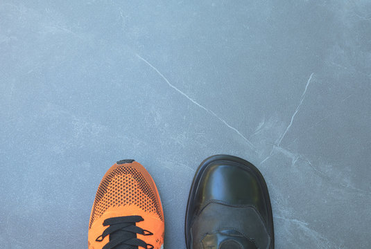 Life balance concept for work and exercise in top view half of business and sport shoes.