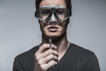 Serious guy protects himself from smoking harm