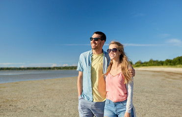 happy couple hugging on summer beach